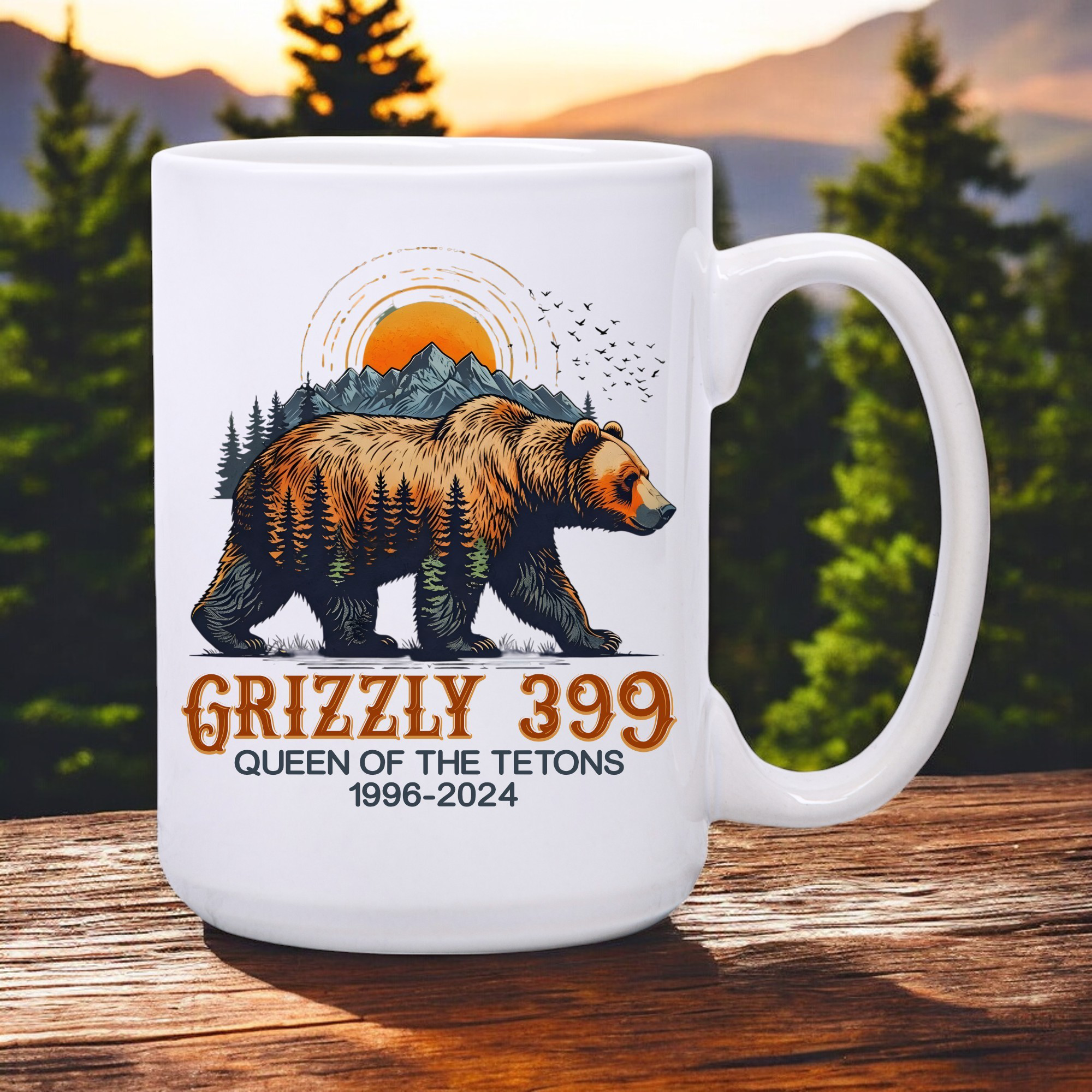 White 15oz ceramic coffee mug that has a drawing of Grizzly 399 with the Teton Mountains in the background and under the bear the wording states Grizzly 399 Queen of the Tetons 1996-2024.